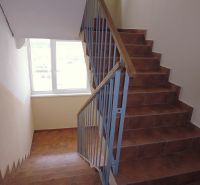 A staircase with a window and railing in a 2-room apartment.