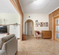 Living room in a three-room apartment with a wooden decor floor and furniture.