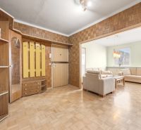 A hallway with wooden decor and entrance to the living room in a 3-room apartment.