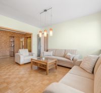 Living room in a 3-room apartment with sofas and a wooden decor floor.