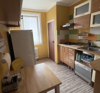 The kitchen of a 2-room apartment, equipped kitchen unit and floor with a wooden decor.