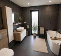 A bathroom in a family house with a bathtub, a sink, and dark tiles.