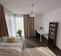 Interior of a family house with a bright room, a bed, and a floor with a wooden decor.