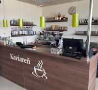 Interior of a café with wooden decor, counter, shelves, and a coffee machine, optimized for gastro spaces.