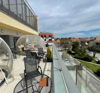 Terrace on Trojičné Square in Trnava with seating in gastro premises.