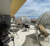 Terrace in Trnava on Trojičné Square with gastro spaces and transparent domes.
