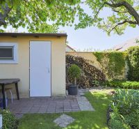 A garden at a family house on Hollého Street in Stupava, with a storage shelter.