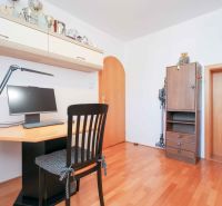 A workspace with a computer and a wooden decor floor in a family house.