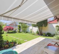 Terrace of a family house on Hollého Street in Stupava with a garden and an awning.