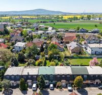 Aerial view of family houses in Stupava on Hollého Street with extensive surrounding countryside.