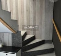 A staircase with wooden paneling and tiles in a family house.