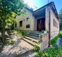 A family house in the Old Town on Búdková Street surrounded by greenery and trees.