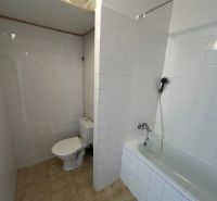 Bathroom in a 2-room apartment with a bathtub and toilet.
