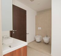 Bathroom with a shower, sink, toilet, and bidet in a 3-room apartment.