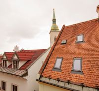 The church tower protruding above the roofs in Bratislava on Beblavého Street.