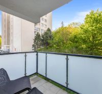 Balcony of a 2-room apartment in Bratislava - Old Town with a view of greenery and a building.