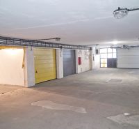 The interior of a garage with multiple doors, a well-lit and spacious area.