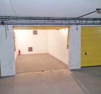 Garages on Majerníkova Street in Bratislava with open parking spaces and yellow doors.