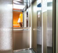 The interior of an elevator in a 3-bedroom apartment with a visible entrance to the staircase.