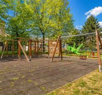 A children's playground surrounded by trees on Krivá Street in Košice, Juh district.