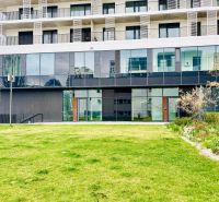 Building with a glass facade and lawn in Bratislava - Ružinov on Prístavná Street.