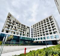 Modern apartment complex on Prístavná Street, Bratislava - Ružinov, surrounded by greenery.