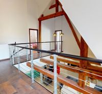 A family house with a wooden decor floor and wooden structures in the interior.