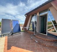 A family house in Veľké Chlievany with a spacious terrace and solar panels.