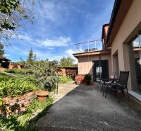 A family house in Veľké Chlievany with a terrace, garden, and blue sky.