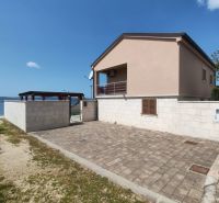 A family house in BIBINJE with a terrace by the sea and a paved courtyard.