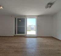 A room with a wooden floor decor and balcony doors in a family house.