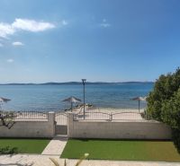 Sea view and terrace at a family house in Bibinje with beach umbrellas.