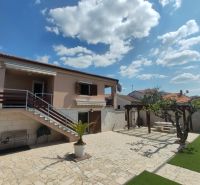 A family house in Bibinje with stairs, a terrace, and a gallery, surrounded by a garden.