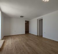 A large bright room in a family house with a wooden decor floor.