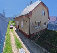 A family house in the village of Svinná with a garden and a parking area in the yard.