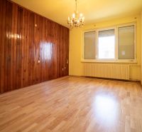 A room with wooden paneling and a floor with a wooden decor in a family house.