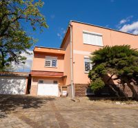A family house on B.Tablica Street in Dudince with a garage and trees in the garden.