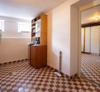 Interior of a family house with a tiled floor and wooden cabinets in Dudince, on B.Tablica.