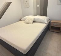 A bedroom in a family house with a single bed and nightstands.
