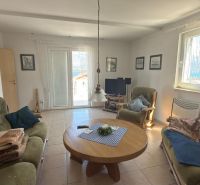 Living room in a family house with comfortable sofas and a wooden coffee table.