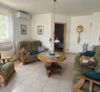 Living room in a family house with a sofa and wooden furniture.
