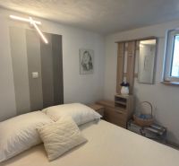 Bedroom in a family house with decorative lighting and pictures on the walls.