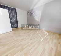 A bright room with a wood-decor floor, suitable for a studio apartment.