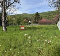 A plot for residential use in Borinka on Borinka street surrounded by greenery, grass, and trees.