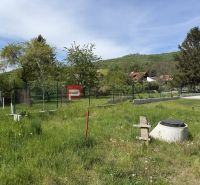 A grassy plot in Borinka, surrounded by trees, suitable for living.