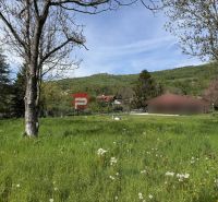Residential plots in Borinka with views of greenery and surrounding hills.