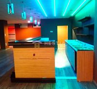 A bar counter with colorful lighting in commercial premises for rent.