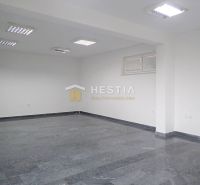 Spacious commercial space with tiles and ceiling lights, suitable for commercial land.
