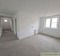White room with a window, concrete floor, outlets for a kitchen unit in a family house.