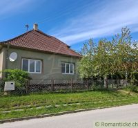 A family house in Orešany with a red roof and a well-maintained garden.